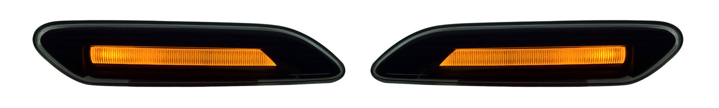 A pair of black automotive side marker lights with integrated amber orange LED lights, shown on a plain white background.