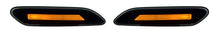 A pair of black automotive side marker lights with integrated amber orange LED lights, shown on a plain white background.