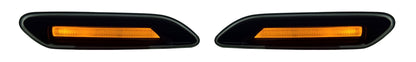 A pair of black automotive side marker lights with integrated amber orange LED lights, shown on a plain white background.