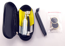 Bicycle repair kit with CO2 canister,  inflation tube, tyre levers and patches in a black zip case on a white background